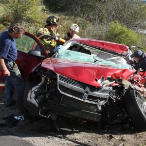 Firefighters use hydraulic extrication equipment while rescue crews tend to driver Eli Ranquist of Rockland after he crashed head-on into an oncoming Freightliner flatbed truck Monday afternoon in Cushing. (Photo courtesy Rockland Fire Department/Alan Athearn)