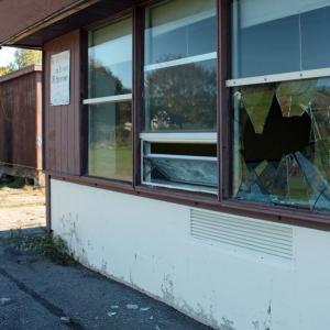 A cinder block was used to smash a hole in this window at the back corner of the closed MacDougal School on Broadway in Rockland. (Photo by Holly S. Edwards)