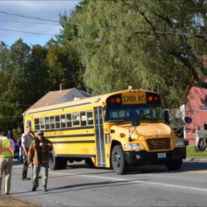 Robert Smith, driver of No. 14 bus of School Adminstrative District 28 (Camden-Rockport) waits patiently for crews to disconnect the power line that landed on the top of his bus so he could safely drive home. (Photo by Lynda Clancy)