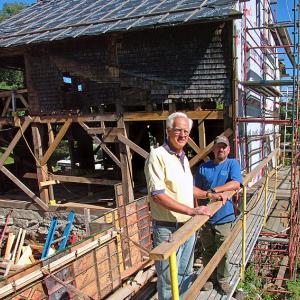 Tony Grassi, of Camden, left, is giving the 19th-Century Freedom Falls Mill a 21st-Century makeover as a commercial property, complete with a hydroelectric generator that will supply the power for the building. Grassi is pictured at the mill with project foreman Jim Rorden, of Cold Mountain Builders. (Photo by Ethan Andrews)