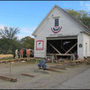 Volunteers get the historic Center School House ready to move across the street. (Photos courtesy of Rob Newcombe)