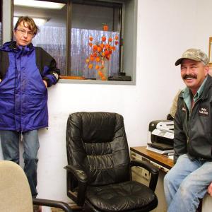 Belfast Transfer Station's newly-hired manager Sandy Carey, left, and longtime operator Steve Roberts enjoy a quiet moment. With the arrival of a new plastics baler that will expand the facility's recycling program, they're expecting to be unusually busy in the coming months. (Photo by Ethan Andrews)