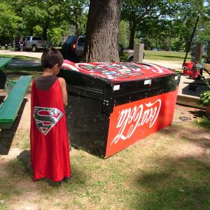 A boy looks at an overturned soda machine by The Spot in Belfast City Park the day after three men vandalized the concession, the nearby municipal pool and two downtown businesses. (Photo by Ethan Andrews)
