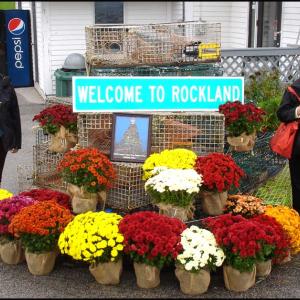 Phyllis Schwartz and Elayne Kollins, of Las Vegas, and The World residents pose beside the welcome to Rockland sign.