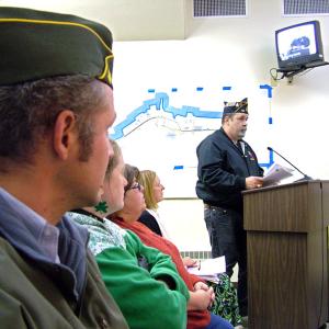 Veteran Timothy Parker, at the podium, was one of a number of residents who came to City Hall on Tuesday night to speak out against the idea of putting creative lighting and seating on the footbridge, officially known as the Armistice Bridge. (Photo by Ethan Andrews)
