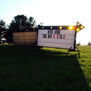 With small populations and hand-counted ballots, small towns like Knox, pictured here, were able to submit final election tallies on Election Night. But in Belfast, multiple polling places, a larger population and a voting machine hitch conspired to delay final results for days. (Photo by Ethan Andrews) "Vote Here" sign, Town of Knox