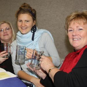 From left, 2012 Hutchinson Center scholarship recipients Dayne Beckett of Belfast, Birgitta Polson of Lincolnville and Tami Miles of Waldo are all smiles with their new glass UMaine steins during the scholarship luncheon Dec. 14. (Photo by Holly S. Edwards)