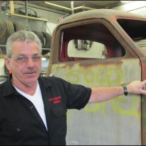 Larry Oakes next to his latest creation, a 1941 Studebaker complete with a custom frame (photo: Kay Stephens)