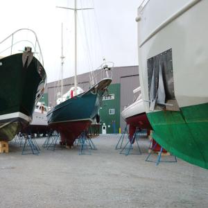 Front Street Shipyard has managed small boats like these with ease but is looking for headroom with a new proposal that gets its first official airing tonight. Two of three versions of the plan, which would include the largest building to date, a new mobile boat lift and pier, involve using city land. (Photo by Ethan Andrews)