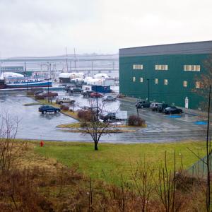 Front Street municipal parking lot, the proposed location for a new Shipyard building that would cover the same area as the adjacent Building 5, right, and stand six-to-10 feet taller. (Photo by Ethan Andrews)