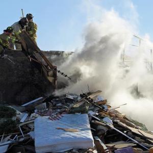 Rockland firefighters pick away at a debris pile fire at the Rockland Solid Waste Facility Saturday afternoon. (Photo courtesy Rockland Fire Department/by Alan Athearn)