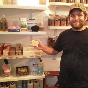 Rick Soloman, co-manager of Sweets and Meats, shows off shelf space for Trillium Soaps (Photo by Kay Stephens)