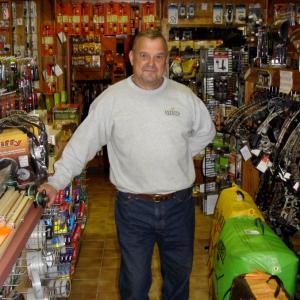Carl Kosmo at his store, The Outdoor Sportsman, in Northport. (Photo by Chris Wolf)