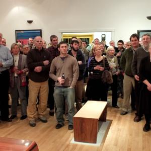 A crowd gathers at the Center for Furniture Craftsmanship in Rockport to appreciate bench design. (Photo by Chris Wolf)