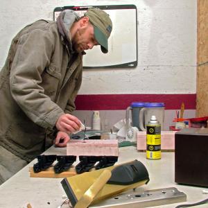 Joe Mathiau of Lincolnville makes plastic door lock covers for Sure Tech Industries, one of two businesses owned by Russell Manton operating out of a suite of offices in Morrill. (Photo by Ethan Andrews) Joe Mathiau of Lincolnville pours plastic resin for hotel door lock covers at the Morrill headquarters of Sure Tech Industries. Security upgrades in the hospitality industry, and more recently the Sandy Hook Elementary School shootings, have given the lock business got an unexpected boost. (Photo by Ethan Andrews)
