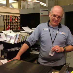Steve Clark, a familiar face behind the counter at the Belfast Post Office, is retiring this week after 28 years at the branch. (Photo by Ethan Andrews) Steve Clark, a familiar face behind the counter at the Belfast Post Office, is retiring this week after 28 years at the branch. (Photo by Ethan Andrews)