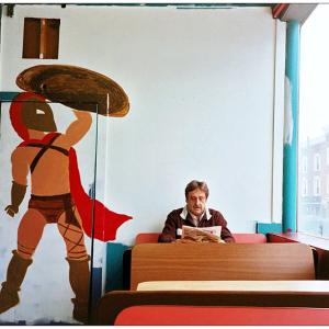 BELFAST - A partially-completed mural of a Spartan warrior at Alexia's Pizza painted by Maleah Chadwick of Searsmont . Owner Ted Rakis, who was born within a mile of the tomb of King Leonidas in Sparta, sits in his customary seat at the restaurant. (Photo by Ethan Andrews)