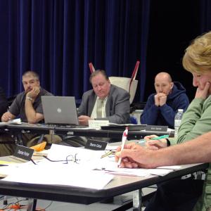 RSU 20 board member Sharon Catus, far right, pauses during emotion-filled comments to the board about the proposed reorganization of her town's elementary school. (Photo by Ethan Andrews)