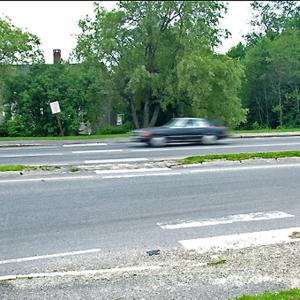 Crossing Route 1 at Route 141 in Belfast was famously risky undertaking before 2009 when the city began a series of improvements aimed at slowing traffic and making safer crossings. The original crosswalk, since relocated, is pictured here. A second round of improvements is in the works. (Photo by Ethan Andrews) Crossing Route 1 at Route 141