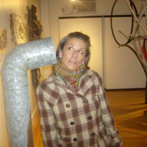 Lisa Diane listens to Bethany Engstrom's "Stand Pipe" installation at the original Resisting Entropy in 2010. (Photo by Kay Stephens)