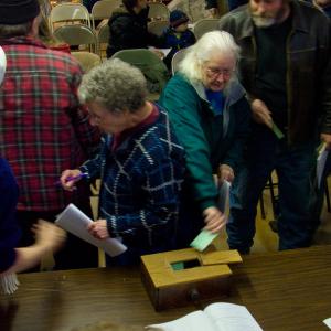 Jackson voters cast ballots during a previous town meeting. The town is one of six in Waldo County that will hold its annual town meeting this Saturday, March 16. Another half-dozen meet later in March. (Photo by Ethan Andrews)