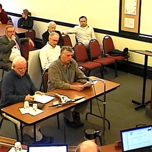 Seated at the table during Monday night's special Camden Select Board meeting are, from left, Ross Stevens and George Sawyer. (Video still courtesy Town of Camden)