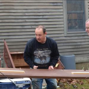 Lincolnville's Town Custodian Roman McDonald and Town Administrator David Kinney clean out old furniture from the town office basement, making trips to the Mid-Coast Solid Waste transfer station in Rockport. (Photo by Lynda Clancy)