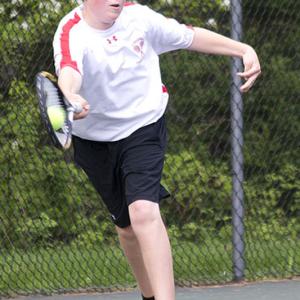 Camden Hills Drew Holt reaches for a return on a serve. (Photo Courtesy of Dwight Pitcairn)