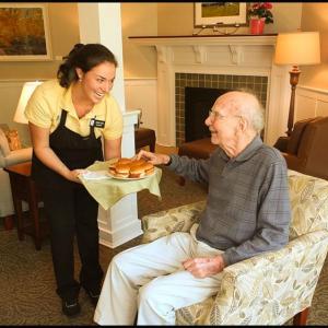 Sarah Bryant (housekeeping and dietary) serves Bartlett Woods resident Richard Neville during the open house on Saturday. "I've been here two weeks," he said. "So far it's been wonderful." (Photos by Chris Wolf)