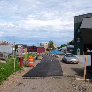 The temporary top end of the Belfast Harbor Walk starts just below the construction site of Front Street Shipyard's new travel lift pier. Heading south from here, the new pedestrian and bicycle path is completely paved through Heritage Park. (Photo by Ethan Andrews)