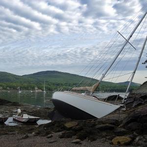Camden Harbormaster Steve Pixley's whaler floats next to the 30-foot sailboat 'Providence' Thursday morning, which is when it was found beached on the one spit of sandy beach on Curtis Island in the outer harbor. (Courtesy Steve Pixley)