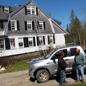 Mike Boucher, right, speaks with Andy Staples, one of the contractors who works on houses Boucher cares for on Islesboro. (Photo courtesy of Tom Groening, Island Institute)