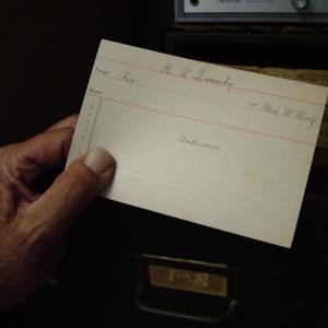 Grove Cemetery Superintendent Steve Boguen holds an index card from his files bearing only a name at the top and the word "unknown." The majority of the cemetery's records have many more details, and as of this week can be searched via the city's website. (Photo by Ethan Andrews)