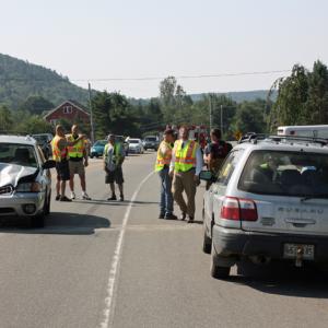 Jean Curtin's crumpled 2004 Subaru is about to be towed off Route 17 in Rockport Wednesday morning, while Police Chief Mark Kelley talk to Alyce Delfino alongside her pickup truck in the parking lot of Green Thumb. (Photo by Holly S. Edwards)