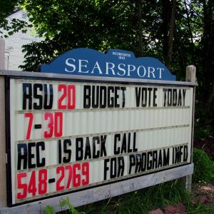 A sign outside municipal offices in Searsport invites participation in the second referendum on the 2013-14 budget for Regional School Unit 20. Turnout was low and the budget was once again defeated. (Photo by Ethan Andrews)