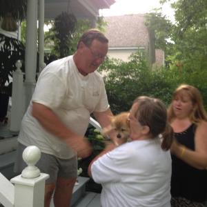 Frank Long, of Camden, hands Skippy to his owner, Jeanette Frost, of Warren. Her daughter, Denise Leary, stands beside her. (Photo by Lynda Clancy)