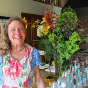 Chef/Caterer Laura Cabot in the Morse kitchen surrounded by flowers from her own garden. Photo by Kay Stephens