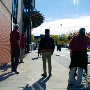 Hannaford employees wait outside Friday morning after an emergency closure of the Belfast supermarket. (Photo by Ethan Andrews)