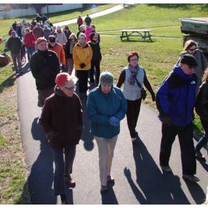 The group marches north through Heritage Park on the way to the trail’s end at the Armistice footbridge. (Photo by Ethan Andrews)