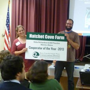 Reba Richardson and Bill Pluecker of Hatchet Cove Farm show off their 2013 Knox-Lincoln Cooperator of the Year sign received for using conservation practices that prevent erosion and protect water quality. Courtesy of Hildy Ellis