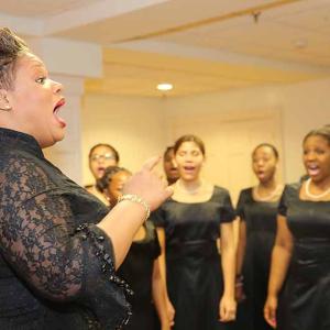 The Rev. Chantel Renee Wright leads members of her Songs of Solomon Gospel Choir in practice before the Dec. 14 concert at Rockport Opera House during Holiday on the Harbor. (Photo by Marti Stone)