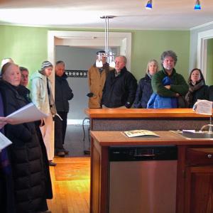 Pierce Atwood attorney Jacob Manheimer, far left, tries to solicit bids from an unwilling crowd during an on-site foreclosure auction of the James P. White house in Belfast, Jan. 28. (Photo by Ethan Andrews)