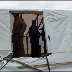 People gather under the shrinkwrap over the schooner Nathaniel Bowditch Friday leading up to a public auction of the boat. (Photo by Chris Wolf)