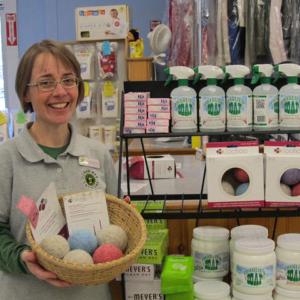 Jennifer Moore Temple, co-owner of Clean Bee Laundry, holds a basket of Maine-made Loo Hoo Wool Dryer Balls. (Photo by Kay Stephens)
