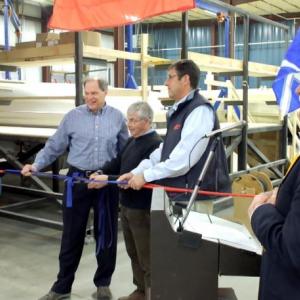 Tim Hodgdon, third from left, assists with the ribbon-cutting at Hodgdon Yachts’ new Damariscotta Facility. RYAN LEIGHTON/Boothbay Register