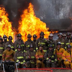 Members of the Rockport Fire Department pose Sunday morning during the final fire that was allowed to finally consume the donated training structure on Route 90. (Courtesy Lincolnville Deputy Fire Chief Mike Eugley)