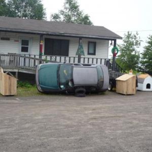 In Willimantic, I met a low-income middle-aged man working on replacing his automobile's exhaust system and transmission that he proclaimed were "pooched." Since he didn't have jacks or blocks, the vehicle, drained of all fluids, was tipped on its side. Deflated tires were wedged under the doors to prevent the vehicle from rolling over. A Chilton's Auto Repair Manual sat open on top of a block of wood for easy reference. (Photo by Ron Joseph)