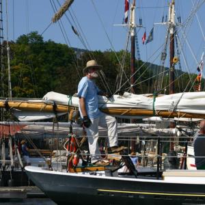 Capt. Jack Moore at the helm of schooner Surprise. (Photo by Holly S. Edwards)