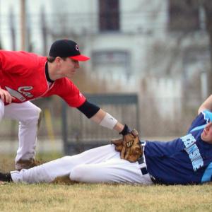 Oceanside’s Riley Sprague slides into third base where Camden Hills Chandler Crans applies the tag, but Sprague was called safe as the umpire said he slid in under the high tag. Sprague scored what would become the winning run. (Photo by Ron Hawkes)