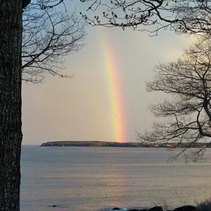 A rainbow pierces Owls Head Friday night.